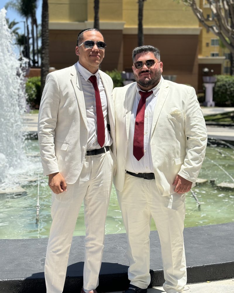 Two members of the Venture Coast Marketing team in matching suits outside their Jacksonville office